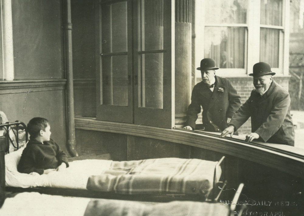 Young patient having a chat with two older gents through the open windows of Royal Alexandra Hospital, c. 1900.